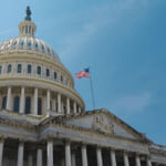 Image, United States Capitol building, blue sky, American flag waves
